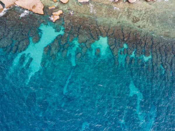 Rocky reef and turquoise water aerial